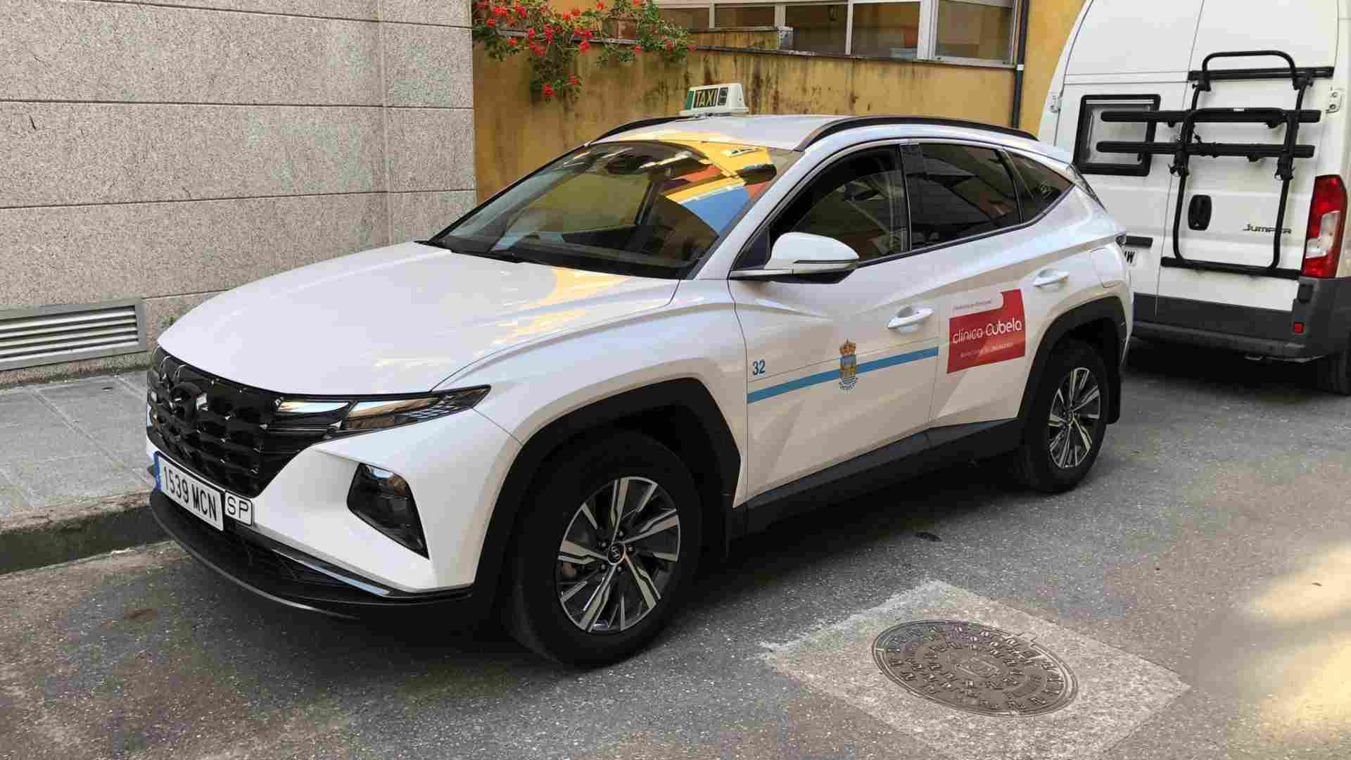 Coche blanco de Taxi 32 de Pontevedra estacionado en una calle con la ventanilla del conductor entreabierta